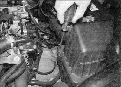 Figure 20.21, a. Remove the two screws securing the cover to the air filter housing...