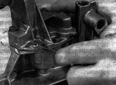 Figure 15.5, a. Remove the oil pump cover mounting bolts...