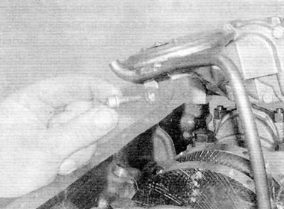 Figure 15.2, a. Remove the bolt securing the dipstick guide tube to the oil pump...