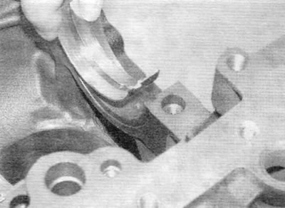 Figure 18.4, a. Install the bearing shells, ensuring that the protrusions enter the grooves in the…