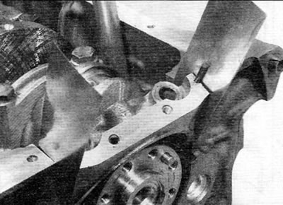 Figure 18.10, a. Installing main bearing cap No. 1 using metal strips to support the side seals