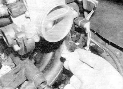 Figure 13.48. ...then release the air intake temperature sensor from the clamp on the throttle body…