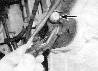 Figure 13.52, a. Disconnect the electrical connector and remove the screw (marked with an arrow)...