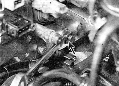 Figure 5.16, b. Unscrewing the rear nut securing the high-pressure fuel pump (marked with an arrow)…