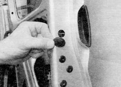 Figure 14.2, a. Remove the plastic cover on the edge of the door...