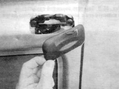 Figure 14.18. Carefully remove the plastic trim panel from the door latch
