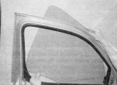 Figure 15.5. Lower the front edge of the glass and remove it from the outside of the door frame