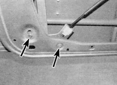 Figure 15.9. Remove the two lower bolts (marked with arrows) fastening the rear guide channel to…