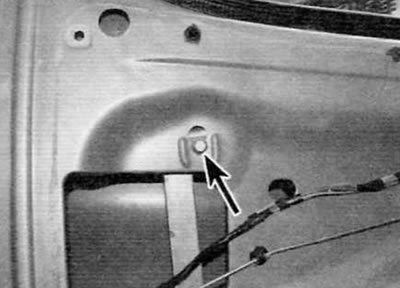 Figure 15.10. Remove the top bolt (marked with an arrow) fastening the rear glass guide channel to…