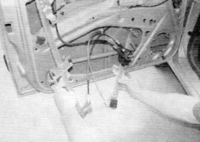 Figure 15.14. Remove the window regulator through the opening in the door