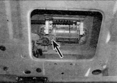 Figure 17.4, a. Unscrew the nut (marked with an arrow) fastening the lock cylinder to the outer…