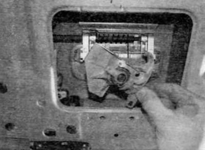 Figure 17.4, b....and remove the lock cylinder through the opening in the trunk door