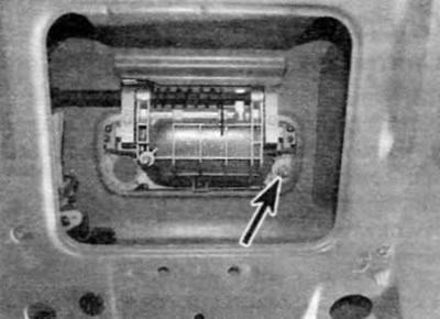 Figure 17.5, a. Unscrew the remaining nut (marked with an arrow)...