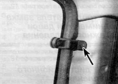 Figure 21.2. Remove the screws (one of them is marked with an arrow) fastening the window glass…