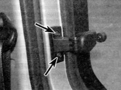 Figure 21.4. Remove two screws (marked with arrows) fastening the door window glass closing latch…