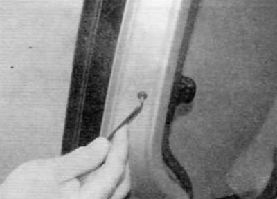Figure 21.5. Remove the third screw securing the latch to the outer edge of the door frame