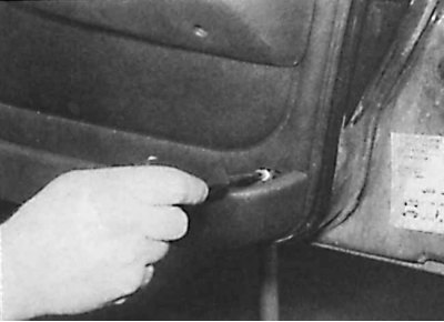 8. Unscrew the three armrest mounting screws and remove the armrest.