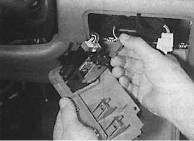 3. Remove the switch cluster from the instrument panel and disconnect the electrical connector.