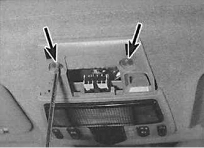 2. Unscrew 2 screws (indicated by arrows) fasteners and lower the upper console down.