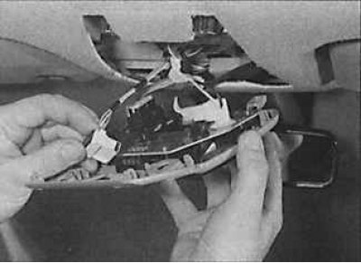 3. Disconnect the electrical connectors and remove the overhead console from the vehicle.